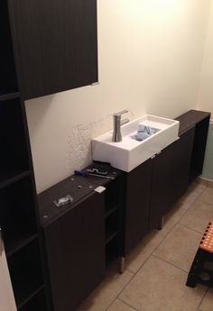 a bathroom that has a sink and cabinets in it