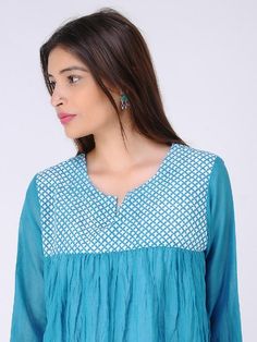 Blue gathered block-printed cambric mul top Garment measurements (in Inches): Size XS : Bust-34", Shoulder-14", Length-30", Sleeve length-17" Size S : Bust-36", Shoulder-14.5", Length-30", Sleeve length-17" Size M : Bust-38", Shoulder-15", Length-30", Sleeve length-17" Size L : Bust-40", Shoulder-15.5", Length-30", Sleeve length-17" Size XL : Bust-42", Shoulder-16", Length-30", Sleeve length-17" Size XXL : Bust-44", Shoulder-16.5", Length-30", Sleeve length-17" Size 3XL : Bust-46", Shoulder-17", Blue Block Print Tops For Spring, Blue Cotton Tops With Ikat Print, Anarkali Style Straight Kurta Top With Printed Motifs, Cotton Long Sleeve Tops With Cutdana, Blue Cotton Straight Kurta Tops, Traditional Blue Blouse With Printed Motifs, Cotton Top With Bandhani Print For Navratri, Anarkali Straight Kurta Tops For Summer, Cotton Bandhani Print Tops For Navratri