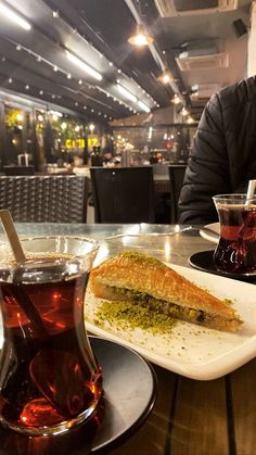 a man sitting at a table with food and drinks