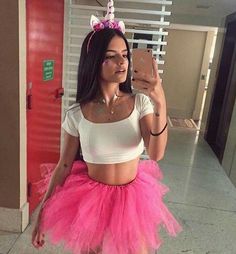 a woman taking a selfie wearing a pink tutu