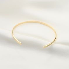 "14K gold cuff bracelet. 14K Gold Minimalist Cuff Bracelet, Delicate cuff bracelet. The bracelet will be shipped in a gift box * 14K solid gold. It is about 2.5mm width. Please select the size of your wrist. If your wrist is 6\", please purchase a 6\" bracelet. (If you order a 6\" bracelet, actual cuff length will be 5\" plus 1 inch opening.) Please read our policies before you place your order. https://www.etsy.com/shop/SashJewelry/policy?ref=shopinfo_policies_leftnav To see other Mother daught 14k Gold Polished Minimalist Cuff Bracelet, Minimalist 14k Gold Cuff Bracelet With Polished Finish, Minimalist 14k Gold Cuff Bracelet Gift, Minimalist Open Band Cuff Bracelet, Minimalist Polished Cuff Bracelet For Wedding, Gold Minimalist Cuff Bangle, Gold Cuff Bangle Minimalist Style, Minimalist Gold Cuff Bangle, Minimalist Formal Bracelets With Open Band