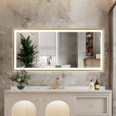 a bathroom with a large mirror over the sink and two mirrors on the wall above it