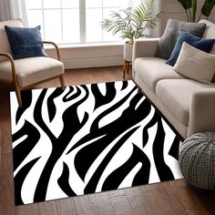 a living room with a couch, chair and rug in black and white zebra print