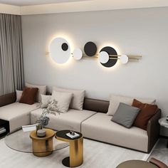 a living room with couches, tables and two circular lights on the wall above them