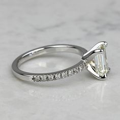 a white gold engagement ring with a pear shaped diamond