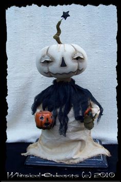 a creepy doll with two pumpkins on it's head