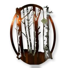 a metal clock with trees on it