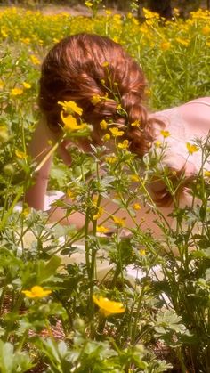 a woman laying down in a field of flowers