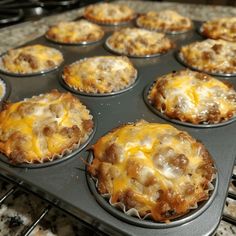 a muffin tin filled with mini meat and cheese pies sitting on top of an oven