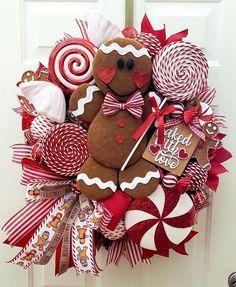 a wreath made to look like a gingerbread man with candy and lollipops