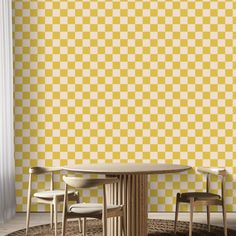 two chairs and a table in front of a yellow checkerboard wallpapered room