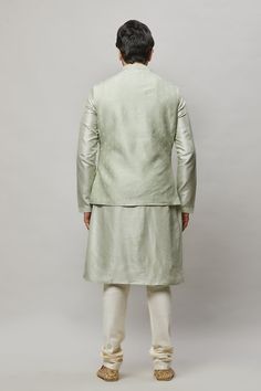 Cotton Linen blended kurta with ivory thread embroidered vest plus ivory churidar. The cotton-linen blend makes it one of our lightest and most breathable kurtas. Crafted with a collar neckline, full sleeves, and front button closure. Occasion: Can be worn to events like Sangeet, Mehendi, & Wedding WASH CARE INSTRUCTIONS - Please Dry clean only when it is applicable. Slight color variation is possible due to digital photography. Unstitched Pista Green Bandhgala Straight Kurta, Ivory Kurta For Men, Pista Colour Kurta For Men, Embroidered Cream Nehru Jacket Straight Kurta, Light Green Kurta For Men, Mehendi Wedding, Embroidered Vest, Vest Set, Mens Kurta