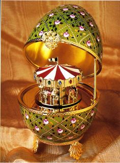 an ornately decorated egg with a carousel in it