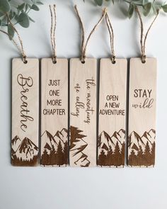 three wooden tags with the words, just one more adventure and stay wild on them