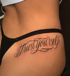 a woman's stomach with the words trust yourself tattooed on her lower side ribcage