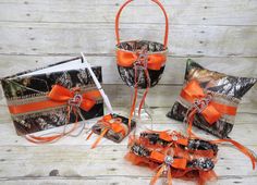 camo wedding baskets with orange ribbons and bows for the bride's special occasion