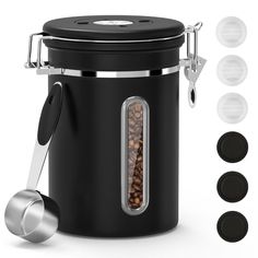 a black canister with four different lids and spoons in front of the container