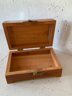 an open wooden box sitting on top of a table