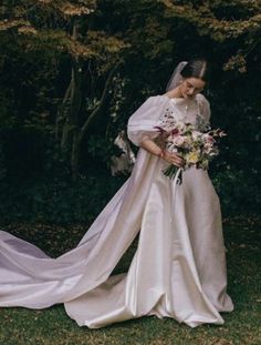 a woman in a wedding dress holding a bouquet