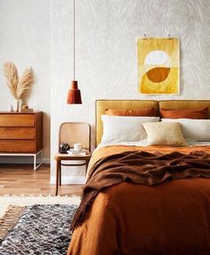 a bed room with a neatly made bed and brown comforter on top of it