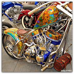 a colorful motorcycle is parked on the street with other motorcycles in the backgroud