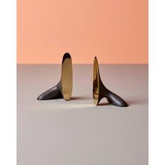 two black and gold objects sitting on top of a table