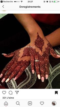 someone has their hands painted with henna