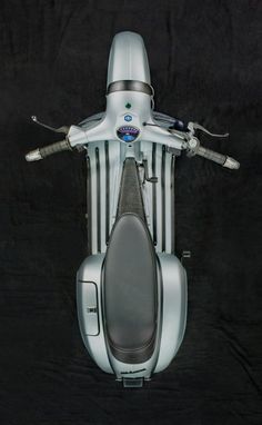 the front view of a silver motorcycle on a black background