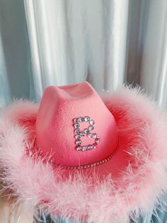 a pink hat with the letter b on it