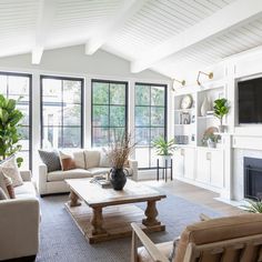 a living room filled with furniture and lots of windows