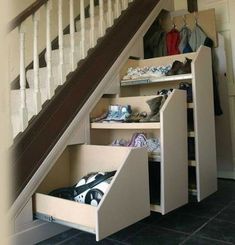 an under stairs storage unit with drawers underneath