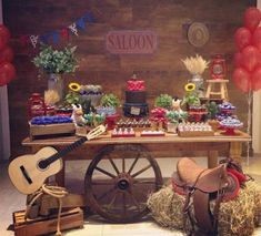 a table topped with lots of food and balloons