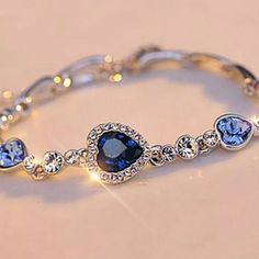 New Silver Bracelet With Beautiful Ocean Blue Rhinestones Gorgeous Blue Hearts And Small Rhinestone Crystals Silver-Tone Measures Approx 9" Lobster Claw Clasp Closure New In Package Other Listings > Halo Princess Ring 14k 18k Gold Plated Cocktail Copper Infinity Bracelet Silver Antique Crystal Dainty Delicate Diamond Ruby Rhinestones Jewelry Anklet Butterfly Purple Oval Heart Love Anniversary Gift Christmas Valentines Emerald Necklace Choker Bracelet Sparkle Simplicity Rosary Fancy Bridal Promis Silver Metal Crystal Bracelet With Stones, Silver Crystal Metal Bracelet With Stones, Elegant Sapphire Crystal Bracelets, Adjustable Blue Jewelry With Sparkling Stones, Blue Adjustable Jewelry With Sparkling Stones, Elegant Blue Bracelets With Sparkling Stones, Sapphire Crystal Bracelet, Blue Crystal Bracelets For Formal Occasions, Elegant Blue Crystal Bracelet With Sparkling Stones