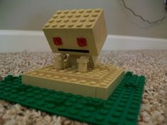 a lego robot is sitting on the ground