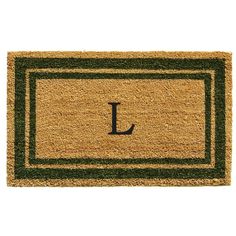 a door mat with the letter r on it and a green border in front of it