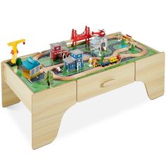 a toy train table with cars and trucks on it