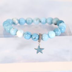 Experience the calming energy of the ocean with our Ocean Starfish Larimar Beaded Bracelet. This beautiful bracelet features a Larimar beaded strand, known for its soothing and healing properties, and is adorned with a charming starfish pendant charm made of solid 925 sterling silver. Add a touch of elegance and serenity to your wardrobe. Materials: Larimar, 925 sterling silver You can choose the option with the starfish charm or without the starfish charm. Jewelry Care: See more information about how to care for your jewelry here. Shipping Policy: Orders will be shipped within 1-3 business days. Economy shipping will take 7-14 days to arrive and standard shipping is 1- 4 days for U.S. orders. International shipping time is depended on the country and per shipping method. Shipping cost wil