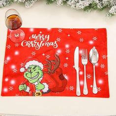 a christmas placemat with the grin face on it and silverware next to it