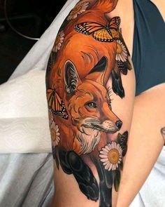 a woman's arm with a fox and butterflies on it