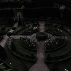 a black and white photo of a formal garden