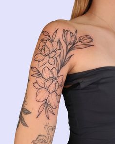 a woman's arm with flowers on it