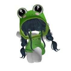 a green frog with long black hair and big eyes sitting on top of a white surface