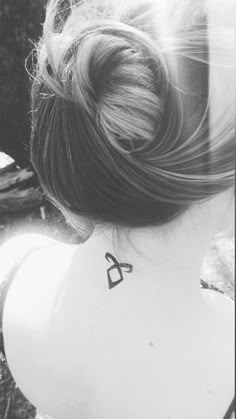 a woman with a tattoo on her neck