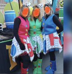 three women dressed in costumes standing next to each other