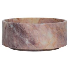 a large pink marble bowl sitting on top of a table