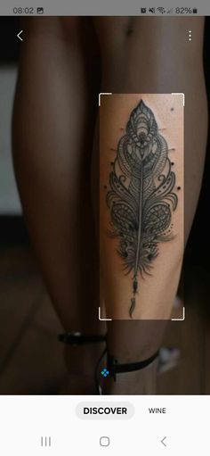 a woman's leg with a tattoo on it and an image of a feather