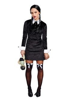 a woman dressed in black and white holding a teddy bear while wearing tights with stockings on them