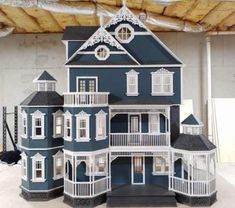 a large blue and white doll house sitting on top of a table