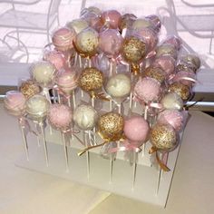 a bunch of cake pops sitting on top of a table