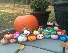 mickey mouse pumpkins are lined up on the porch